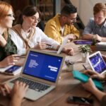 A diverse group of professionals having a collaborative meeting in a modern office setting.